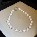 Elegant pearl necklace with delicate woven bead detail, presented in a stylish grey gift box. - Silver