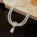 Elegant double-layered pearl necklace featuring a rhinestone flower and teardrop pearl drop - Teardrop Pearl
