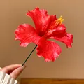 Close-up of a vibrant red fabric hibiscus flower hair pin for beach vacations. - Hair Stick Pink-Six Petal Flower / Pink