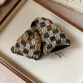 Close-up detail of a triangular tweed hair claw clip with elegant gold and black weaving - 7# Claw Clip - Contrast Tweed Style