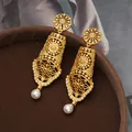 Vintage palace style gold earrings with pearl accents and intricate filigree design. - Hollow Flower / Antique Gold
