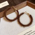 Detailed macro shot of brown fuzzy fabric woven hoop earrings for winter fashion style - Dark Coffee