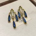 Luxury French vintage earrings with blue teardrop crystals and gold filigree detail - Waterdrop-Blue