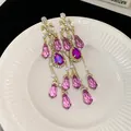 Elegant vintage gold tassel earrings featuring purple crystals and white pearls - Waterdrop-Pink