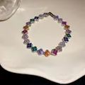 Multicolor zircon clover bracelet with silver finish on a decorative white plate - Silver - Rainbow