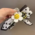 Elegant Korean style polka dot bow hair claw clip featuring a cute smiley flower - No.18 Claw Clip - White Polka Dot Bow Flower