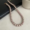 Detailed close-up showing the lustrous texture of champagne pearl necklace beads - 12mm / Champagne