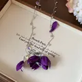 Close-up of elegant purple fabric flower necklace with crystal water drop accents - Purple