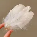 Close-up of ethereal white feather hair clip featuring a large lustrous pearl detail - Duckbill Hair Clips / White