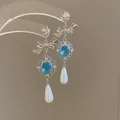 Elegant silver-toned drop earrings featuring a blue crystal bow and teardrop pearl - Bowknot Blue Main Stone Pearl Drop Style (67#)