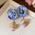 Close-up of elegant fabric flower earrings featuring purple glass drop and gold petals. - Flower Style (HE30866) / Purple