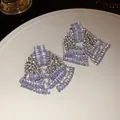Detailed view of sparkling silver needle earrings with multi-layered crystal tassels - Silver Needle - Bowknot Tassel Style / Silver