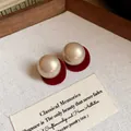 Elegant champagne pearl stud earrings with red velvet base and silver needles design - Red