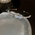 Elegant gold open bangle with sparkling zirconia butterfly motif on a frosted white tray - Style 5 / Silver