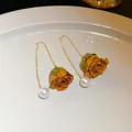 Detailed close-up of elegant gold tassel earrings featuring dried rose and pearl - Rose Pearl (7#)