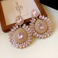 Close-up detail of oversized pink rhinestone flower drop earrings with waterdrop crystals - 21-Stone Style / Pink