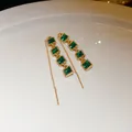 Close-up of elegant gold ear threads with four square emerald green crystals. - Green Square (17#)