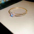 Elegant golden double-row zircon open bangle with sparkling star cluster detail - Style 45 / Gold