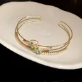 Adjustable golden snake-shaped bangle with micro-pave white and green zircon stones - Style 54 / Gold