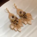 Vintage gold-toned tiger eye stone dangle earrings featuring elegant metallic leaf charms. - Long Tassel Leaf Style (23#)