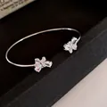 Elegant silver-toned open cuff bracelet featuring twin sparkling zirconia butterfly motifs - Style 58 / Silver