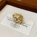 Close-up of elegant gold Pegasus open ring with chain band on a jewelry card. - Pegasus Style / Gold