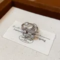Detailed view of an elegant silver Pegasus ring featuring shimmering zircon wings on card - Pegasus Style / Silver