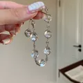 Close-up detail of an elegant silver snowflake beaded bracelet with clear crystal charms - Snowflake Beaded Style / Silver White