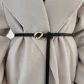 Thin black leather belt for women's coat featuring irregular gold-tone buckle - Black