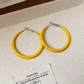 Vibrant yellow enamel hoop earrings with silver pins on a textured beige surface - Circle Style - Large / Large / Yellow