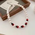 Vintage style pearl necklace featuring cute red and black ladybug charms with adjustable chain - Ladybug Pearl Necklace