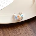 Detail shot of a vintage French shell and stone beaded ring on a cream ceramic plate. - French Vintage Beaded Ring (Round)