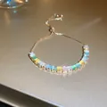 Elegant gold adjustable bracelet with multi-colored pastel rectangular gemstones. - Colorful Square