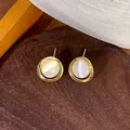 Close-up detail of vintage cat's eye stone stud earrings with gold circle frame - 1# Gold Single Circle Earrings