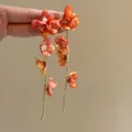 Close-up of elegant orange fabric flower long drop earrings with gold tassels - Orange Gold (7# Ear Clip-Gold-Orange)