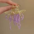 Close-up of elegant gold wire butterfly earrings featuring vibrant purple beaded tassels. - Purple Gold (12# Silver Post-Gold-Purple)