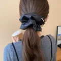 Black satin ruffled oversized hair scrunchie for elegant low ponytail styling. - Black Large Scrunchie