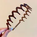 Close-up detail of a retro matte zigzag headband with leopard print for elegant styling - Wave Style