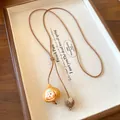 Detailed view of the cute garlic-shaped ceramic pendant on an ethnic style necklace - Garlic Shape