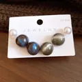 Macro view of six round resin pearl stud earrings on a white jewelry display card - 3 Pairs Set / Silver Pin - Blue - Grey