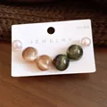 Detail shot of shimmering resin cat-eye earrings and pearls on a white jewelry card - 3 Pairs Set / Silver Pin - Brown - Green