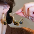 Close-up of vintage resin hoop earrings featuring tortoiseshell pattern and gold charms - Gold Large Hoop with Tortoiseshell Charm (6# Silver Earring Post - Gold - Brown)