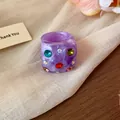 Chunky purple resin ring featuring vibrant multi-colored rhinestones in a Y2K aesthetic - Purple