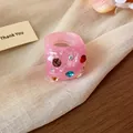 Chunky pink resin ring featuring colorful rhinestones and unique wrinkled texture design - Pink