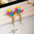 Vibrant colorful fabric flower earrings with long gold tassel fringe on jewelry tray. - Multicolor (65# Steel Post-Multicolor)