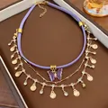 Detail view of multi-layered purple choker with butterfly and gold shell charms. - Purple Butterfly Leather Cord Style (11#) / Purple-Gold