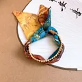 Close-up of artistic ethnic fabric bracelet with Van Gogh style print and gold beaded trim - Oil Painting Style Fabric Open Bangle / Narrow Version / Yellow