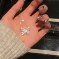 Exquisite sparkly colorful butterfly pendant necklace held in hand to show detail - Colorful Spray Painted Butterfly Style / Silver