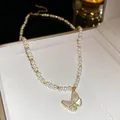 Elegant pearl necklace with a white pearlescent butterfly pendant in gold finish - Style 51 (Real Gold Plated)