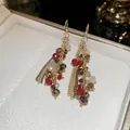 Eleganti orecchini a nappa in stile cinese con perle di cristallo rosse e dorate - Stile a Gancio / Oro Bianco Rosso Caffè Champagne